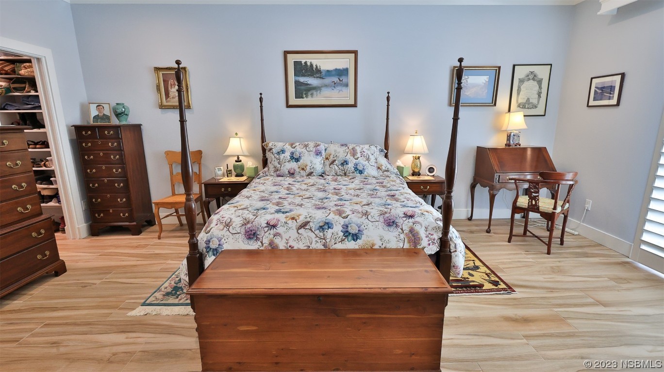 606 Midfield Loop Edgewater, FL 32132 - Photo 24 of 42 a bed sitting in a bedroom and night stand