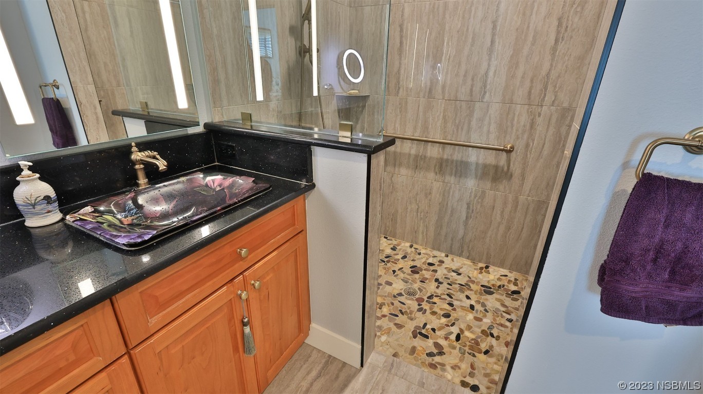 606 Midfield Loop Edgewater, FL 32132 - Photo 29 of 42 a bathroom with a sink and a mirror