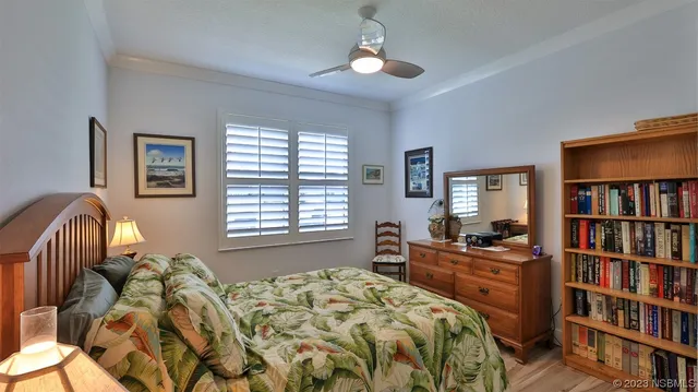 a bedroom with a bed and a book shelf