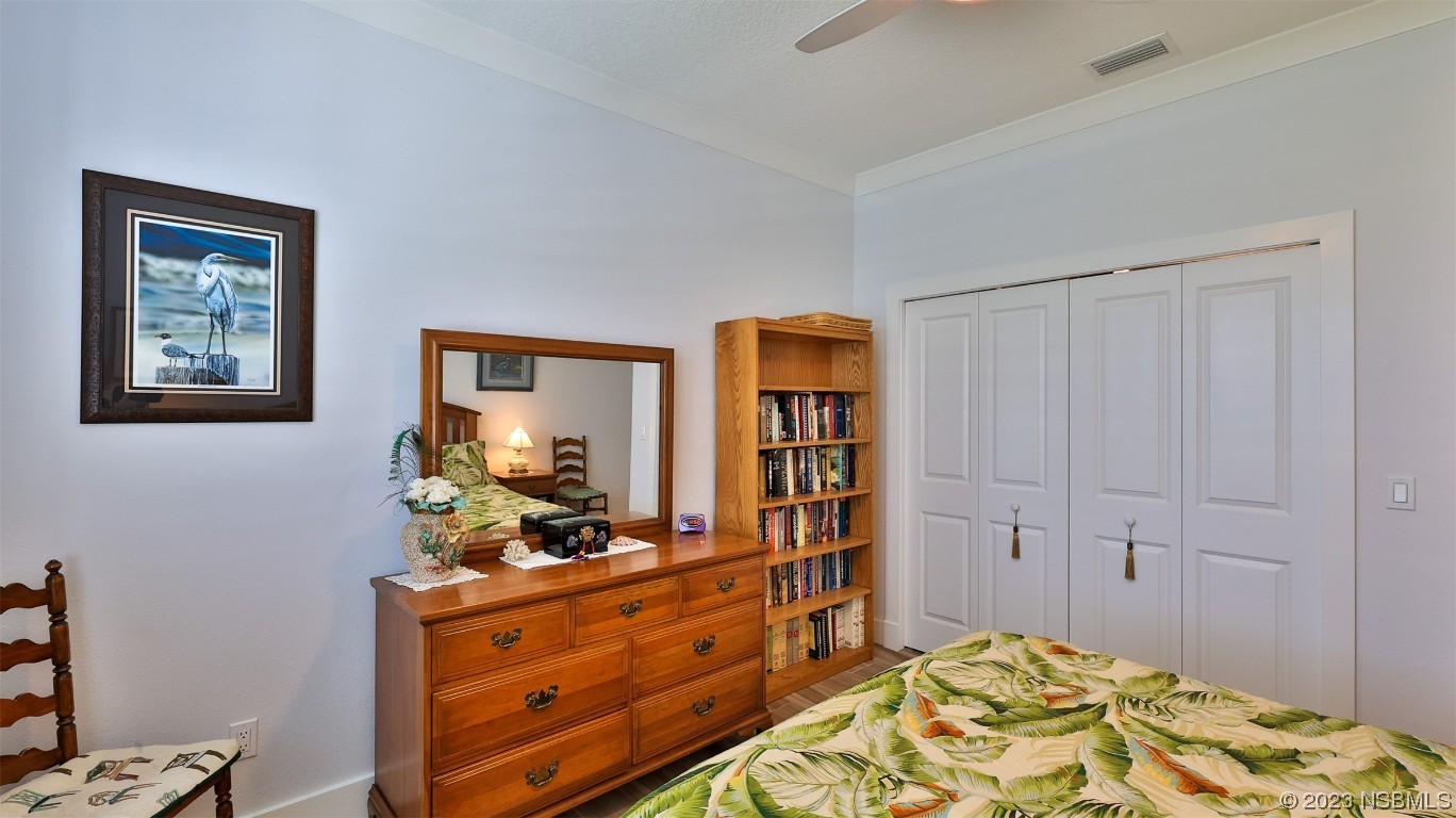 606 Midfield Loop Edgewater, FL 32132 - Photo 32 of 42 a bedroom with a bed and a dresser in it