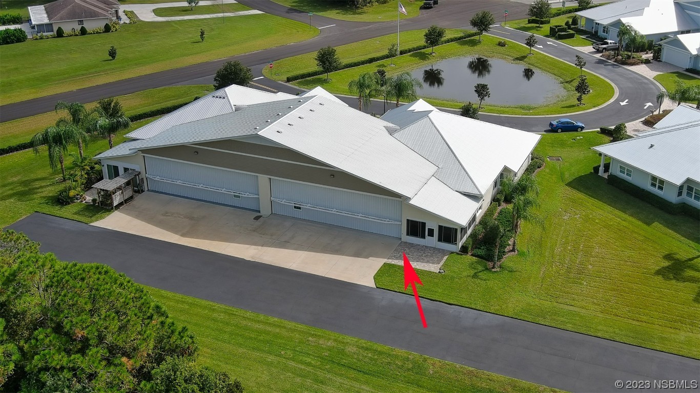606 Midfield Loop Edgewater, FL 32132 - Photo 5 of 42 an aerial view of a house with a garden and lake view