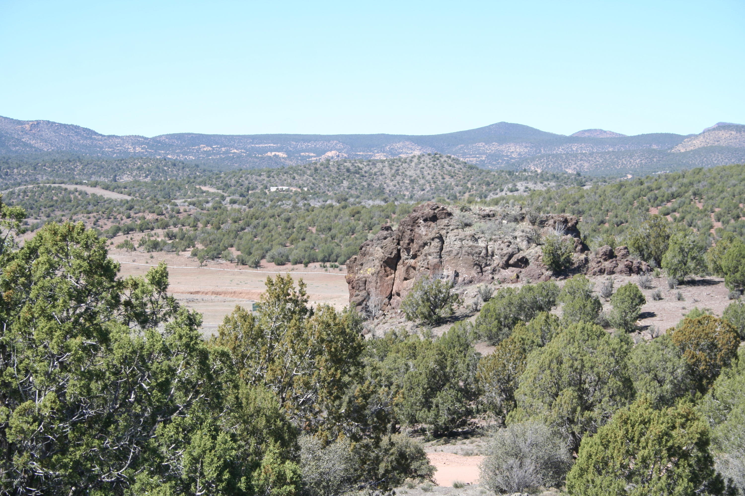 1310 North Willows Ranch Road Kingman, AZ 86401 - Photo 1 of 49 a view of a mountain in the distance in a field