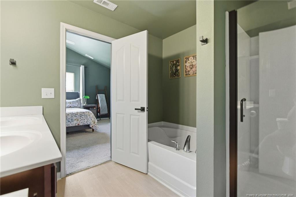 334 Crane Way Bunnlevel, NC 28323 - Photo 34 of 45 a en suite bathroom with a tub shower and bedroom
