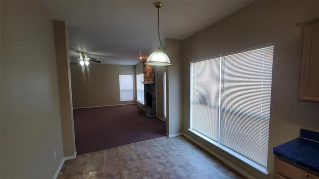 a view of a room with wooden floor and a window