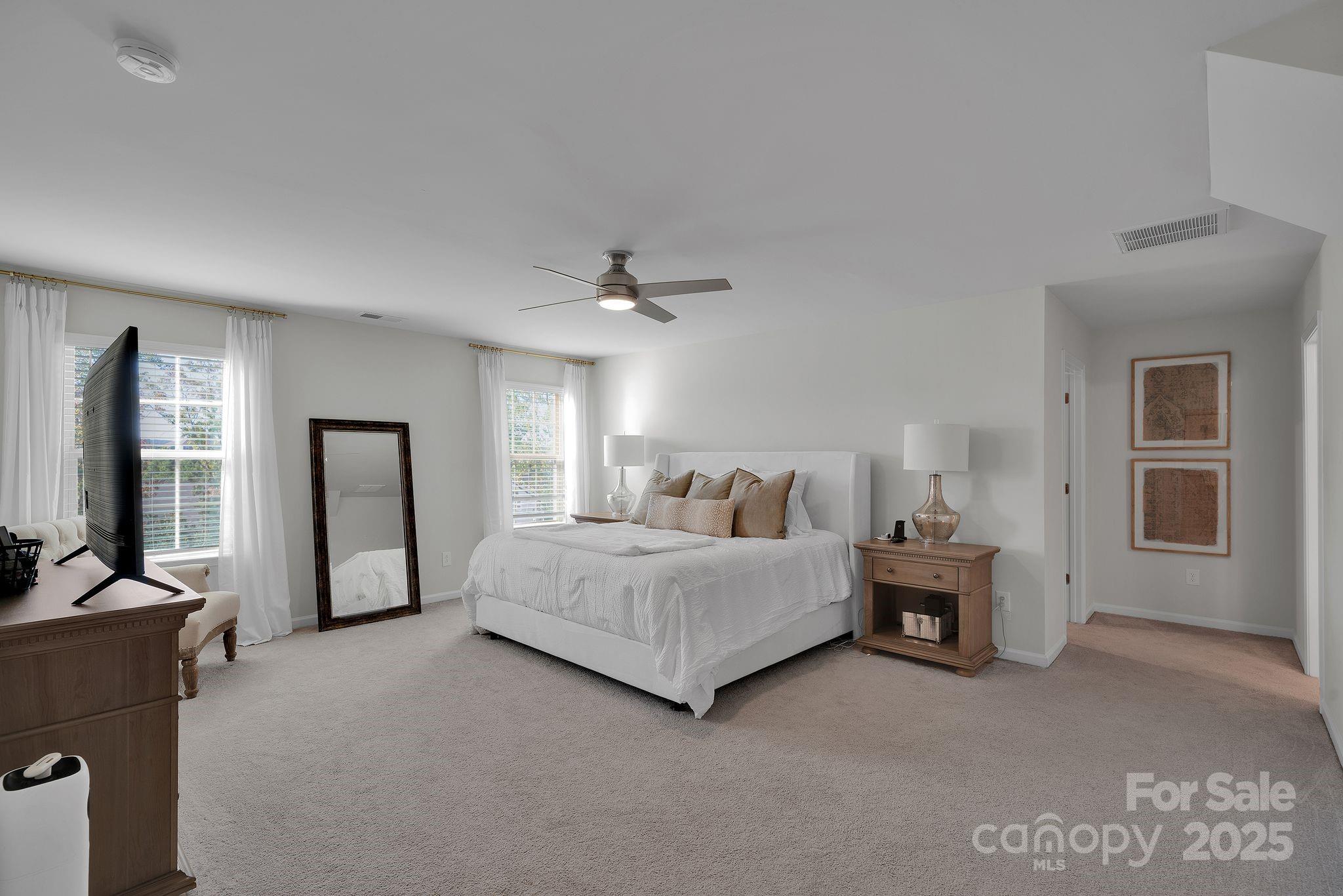 17112 Snug Harbor Road Charlotte, NC 28278 - Photo 22 of 45 a spacious bedroom with a bed and a couch