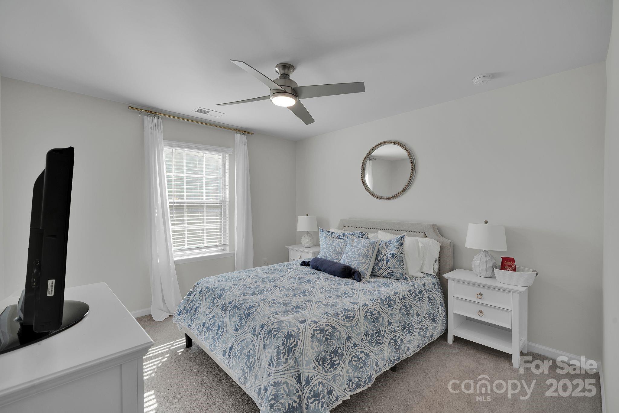 17112 Snug Harbor Road Charlotte, NC 28278 - Photo 28 of 45 a bedroom with a bed a window and dresser