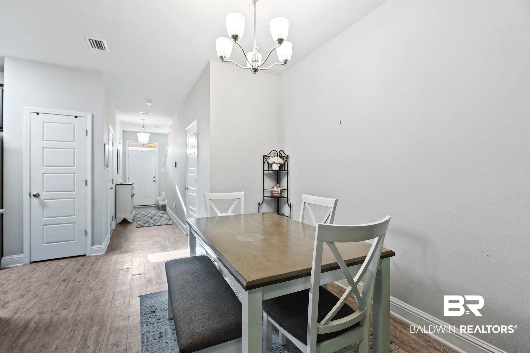 25806 Pollard Road, Unit 24 Daphne, AL 36526 - Photo 14 of 33 Dining space featuring light wood-type flooring and a chandelier