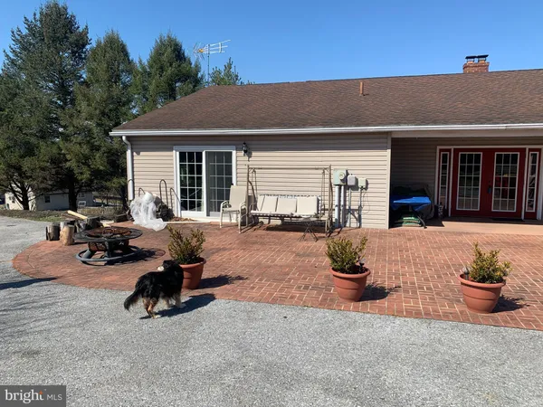a view of house with a yard and roof