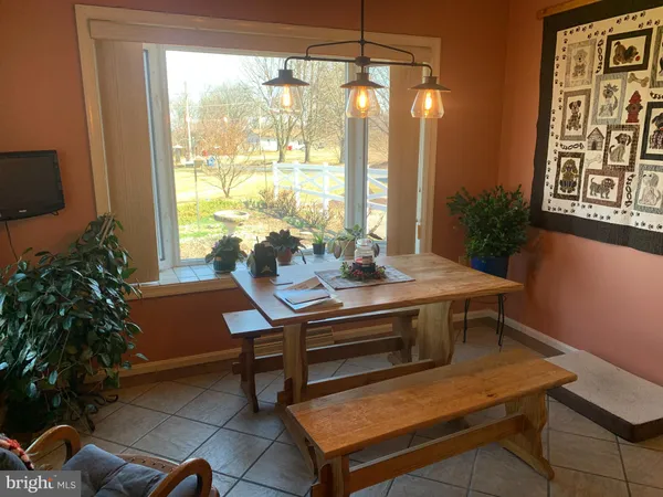 a living room with furniture a chandelier and a window