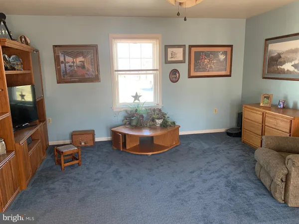 a bedroom with a bed and a mirror on dresser