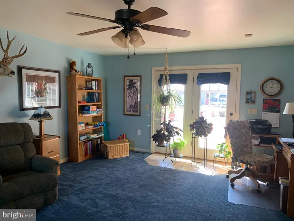 a bedroom with a bed a mirror and dresser