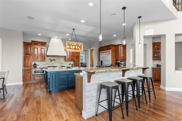 a large kitchen with a table and chairs
