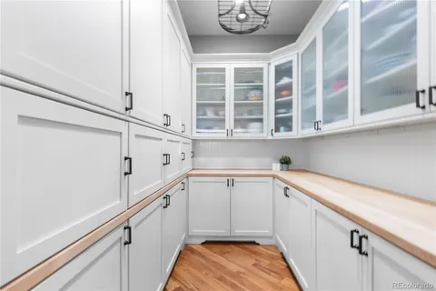 a view of a kitchen with cabinets and wooden floor