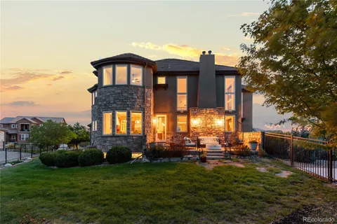 a front view of a house with a garden and plants