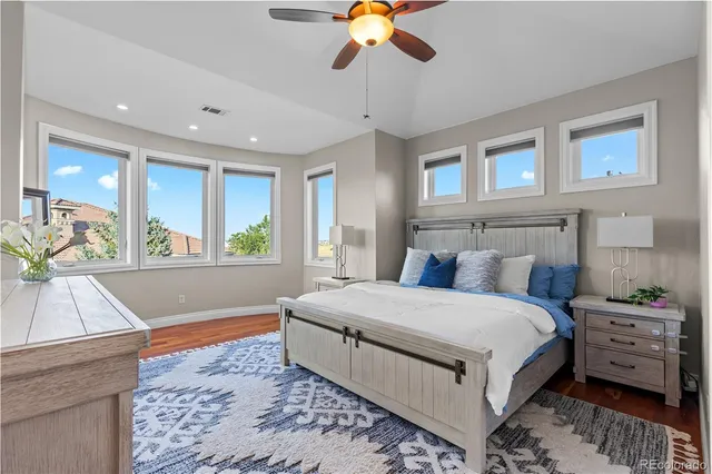 a spacious bedroom with a large bed and a chandelier