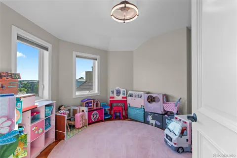 a bedroom with baby toys and a window