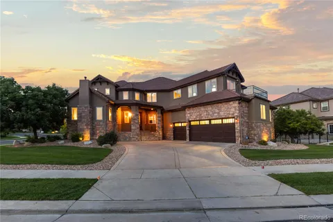 a front view of a brick house with a yard