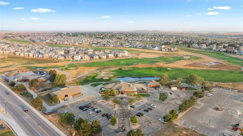 an aerial view of ocean and residential houses with outdoor space