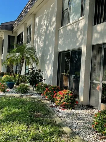 a bed sitting in a bedroom next to a lamp