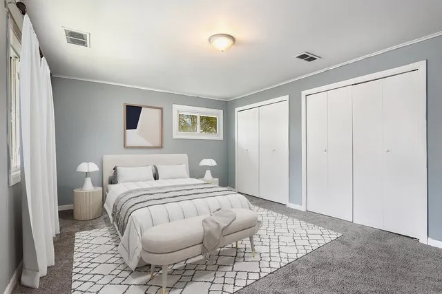 a bedroom with a bed and a painting on the wall