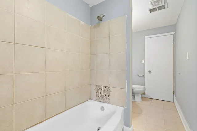 a bathroom with a bathtub and a toilet