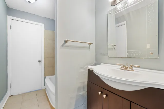 a bathroom with a sink a mirror and a bathtub