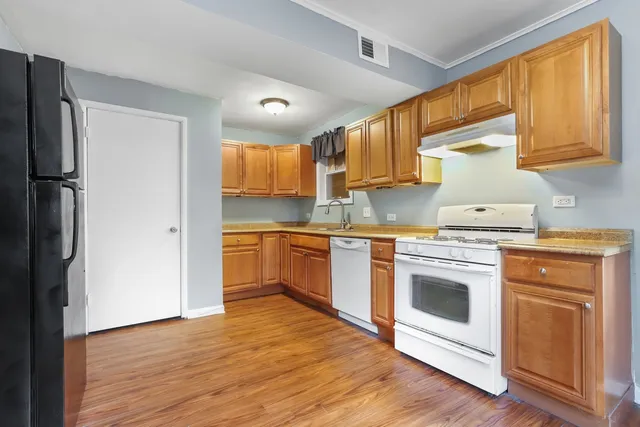 a kitchen with a stove top oven sink and refrigerator