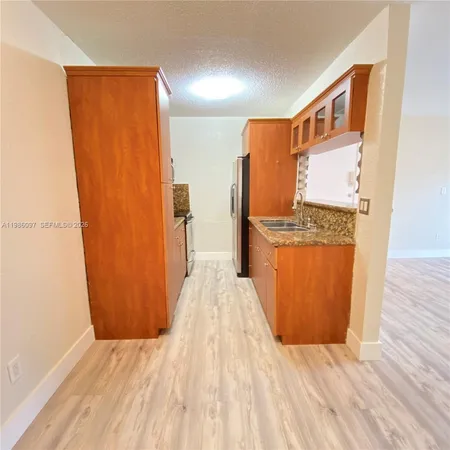 a view of kitchen with wooden floor