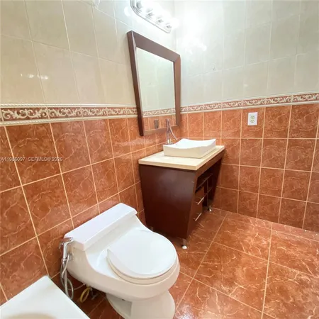 a bathroom with a sink toilet and mirror