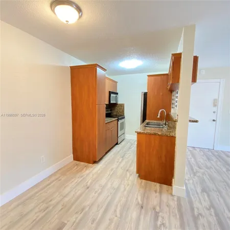 a view of kitchen with wooden floor
