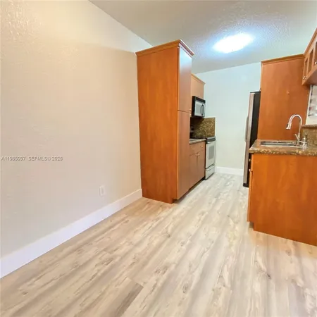 a view of kitchen with wooden floor