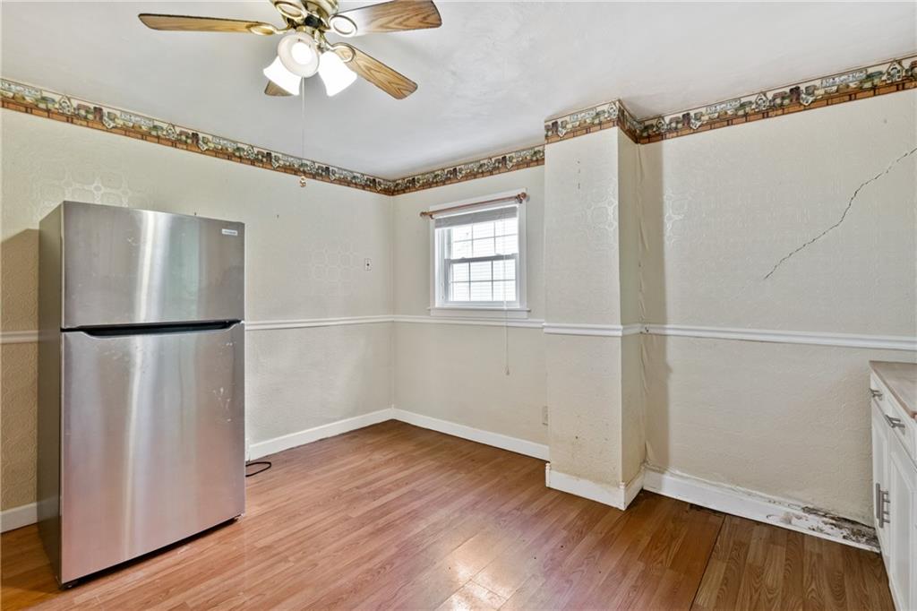 223 Hickory Street McKees Rocks, PA 15136 - Photo 12 of 27 a view of empty room with wooden floor and fan