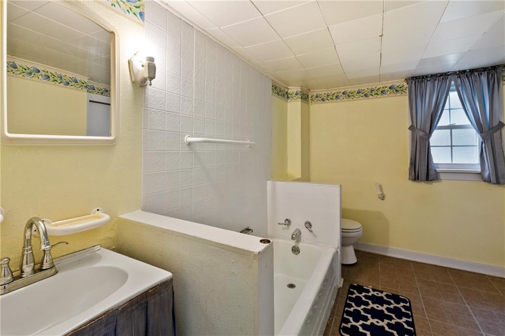 223 Hickory Street McKees Rocks, PA 15136 - Photo 22 of 27 a bathroom with a sink a toilet and shower
