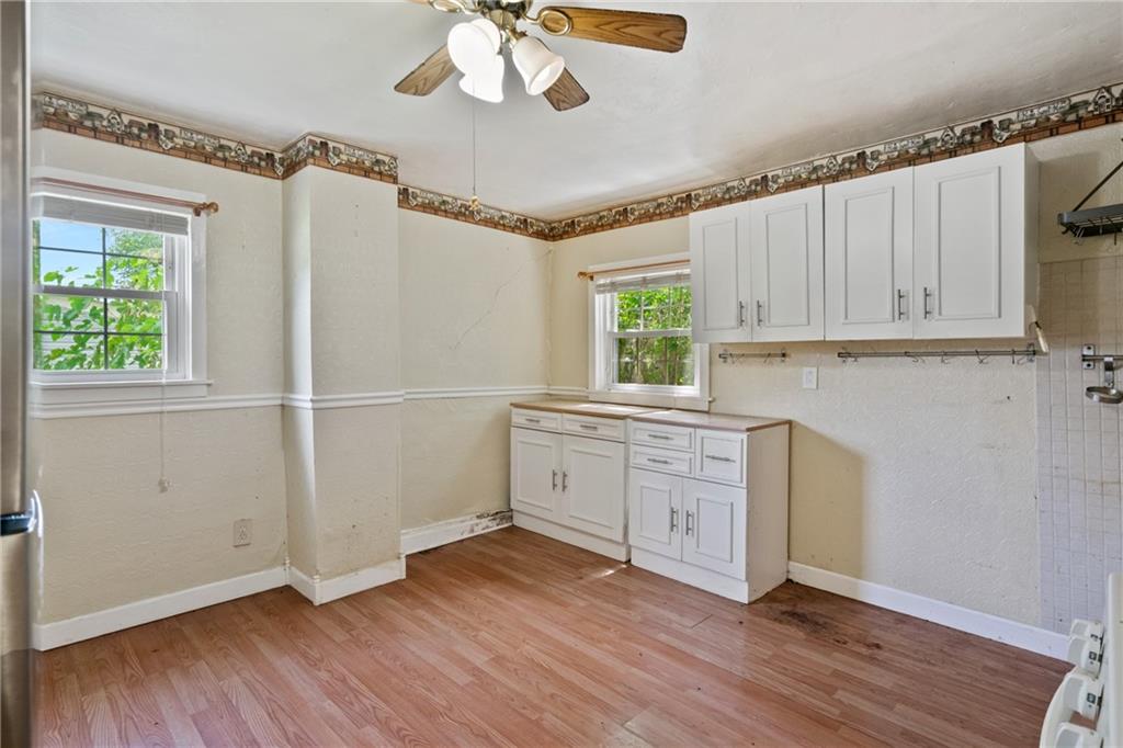 223 Hickory Street McKees Rocks, PA 15136 - Photo 10 of 27 a kitchen with wooden floors and white walls