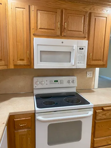 a stove top oven sitting inside of a kitchen