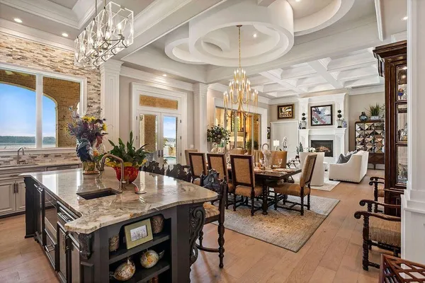 a view of a dining room with furniture a chandelier and wooden floor