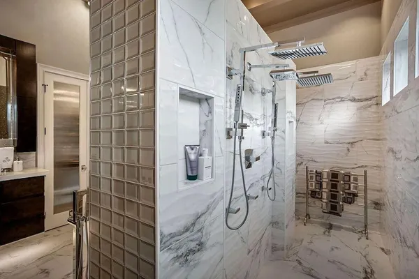 a bathroom with a shower and a mirror