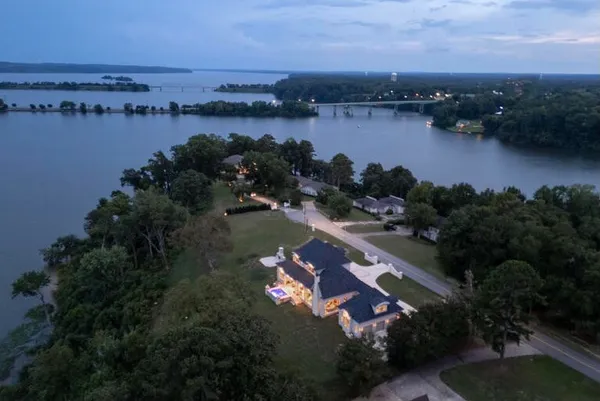an aerial view of lake and residential houses with outdoor space