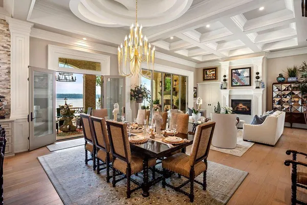 a view of a dining room with furniture a chandelier and wooden floor