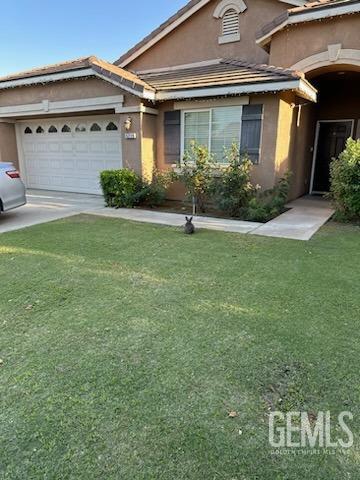 Undisclosed Address Bakersfield, CA 93313 - Photo 2 of 5 a front view of a house with garden