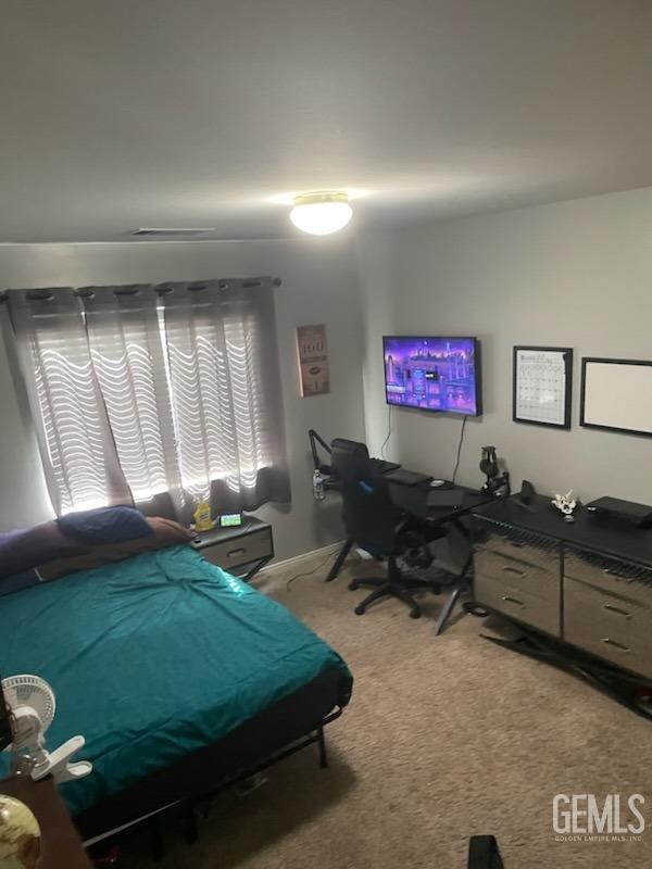 Undisclosed Address Bakersfield, CA 93313 - Photo 4 of 5 a bed room with a bed and a chair