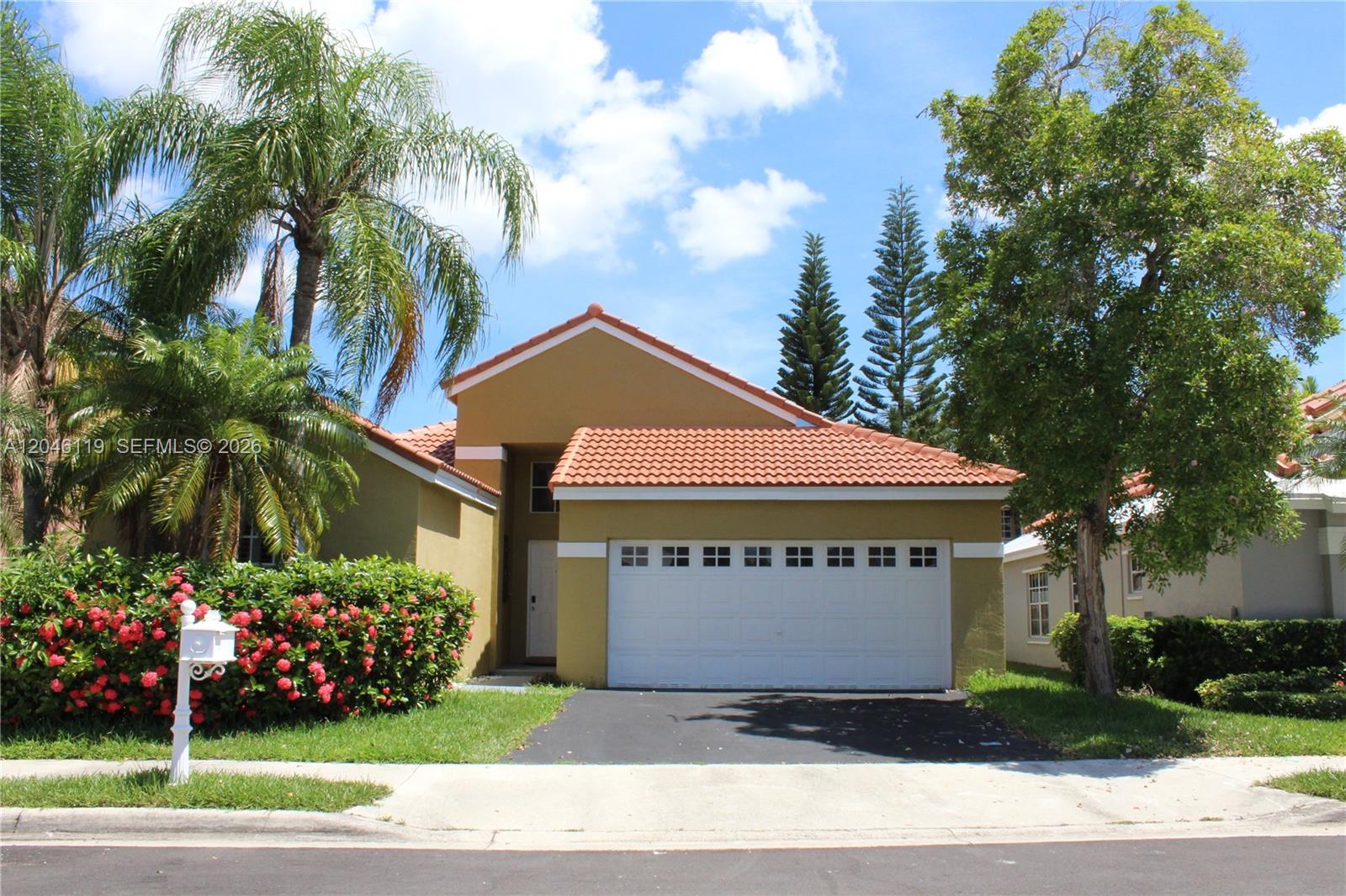 312 Bridgeton Road Weston, FL 33326 - Photo 1 of 13 a view of a house with a yard and potted plants