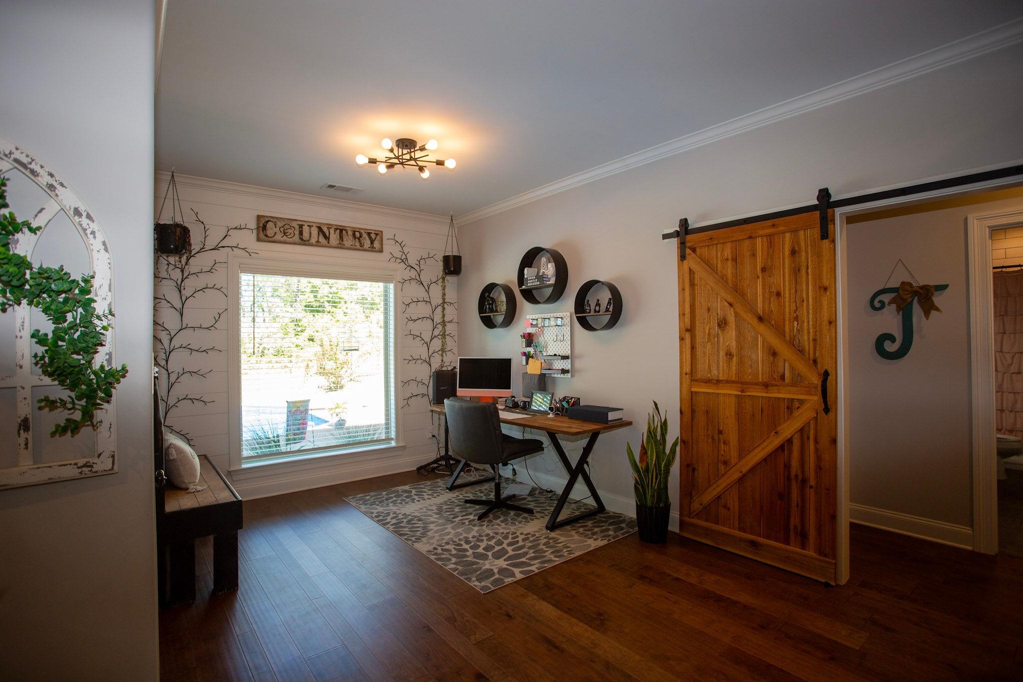 22 Cedar Ridge Cove Atoka, TN 38004 - Photo 11 of 39 Home office with ornamental molding, a barn door, dark hardwood / wood-style floors, and an inviting chandelier