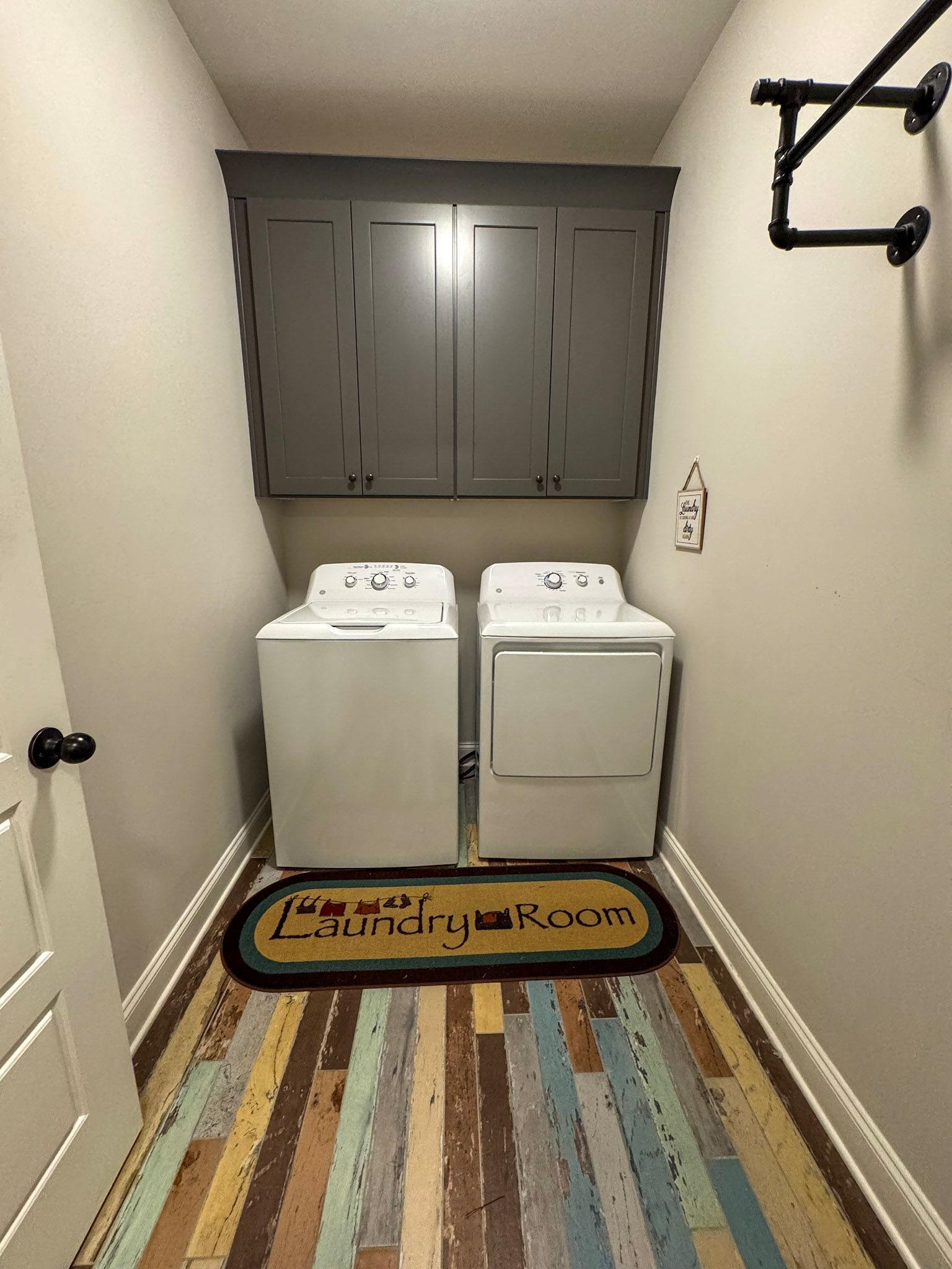 22 Cedar Ridge Cove Atoka, TN 38004 - Photo 13 of 39 Laundry room with cabinets, separate washer and dryer, and dark hardwood / wood-style flooring