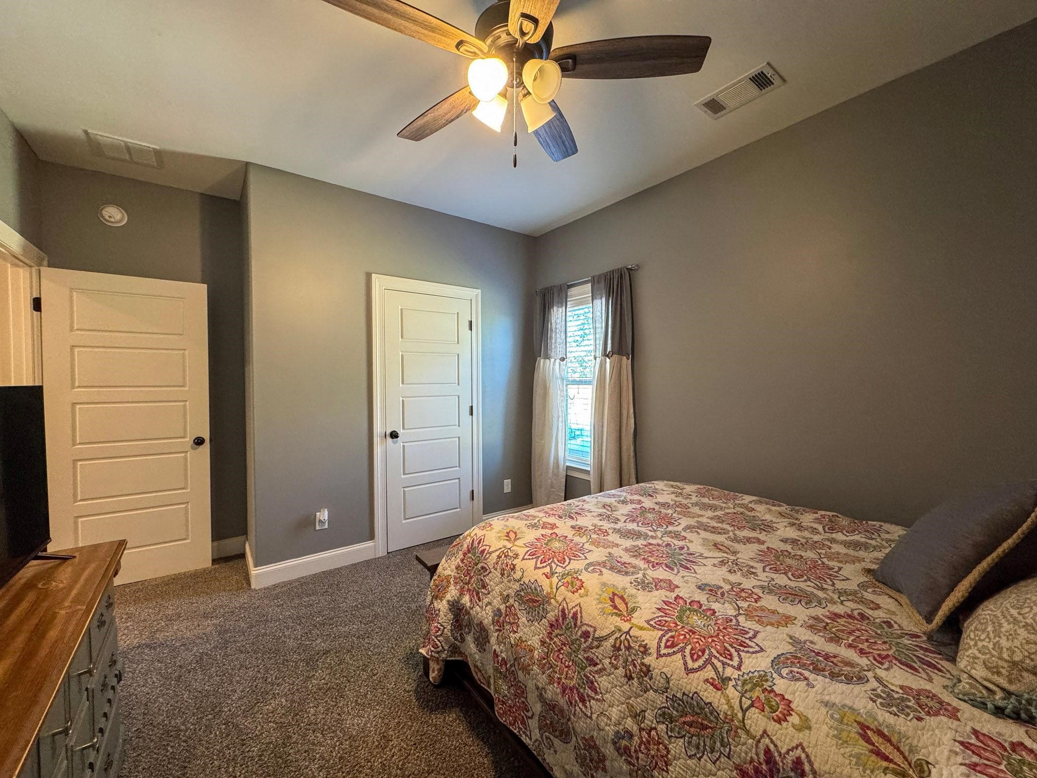 22 Cedar Ridge Cove Atoka, TN 38004 - Photo 14 of 39 Bedroom with ceiling fan and dark colored carpet