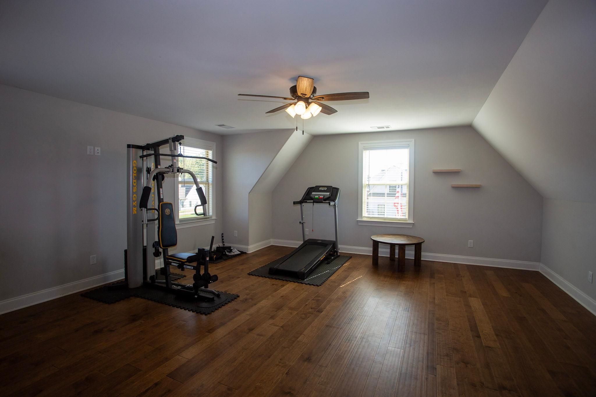 22 Cedar Ridge Cove Atoka, TN 38004 - Photo 18 of 39 Workout area with dark hardwood / wood-style floors, ceiling fan, and vaulted ceiling
