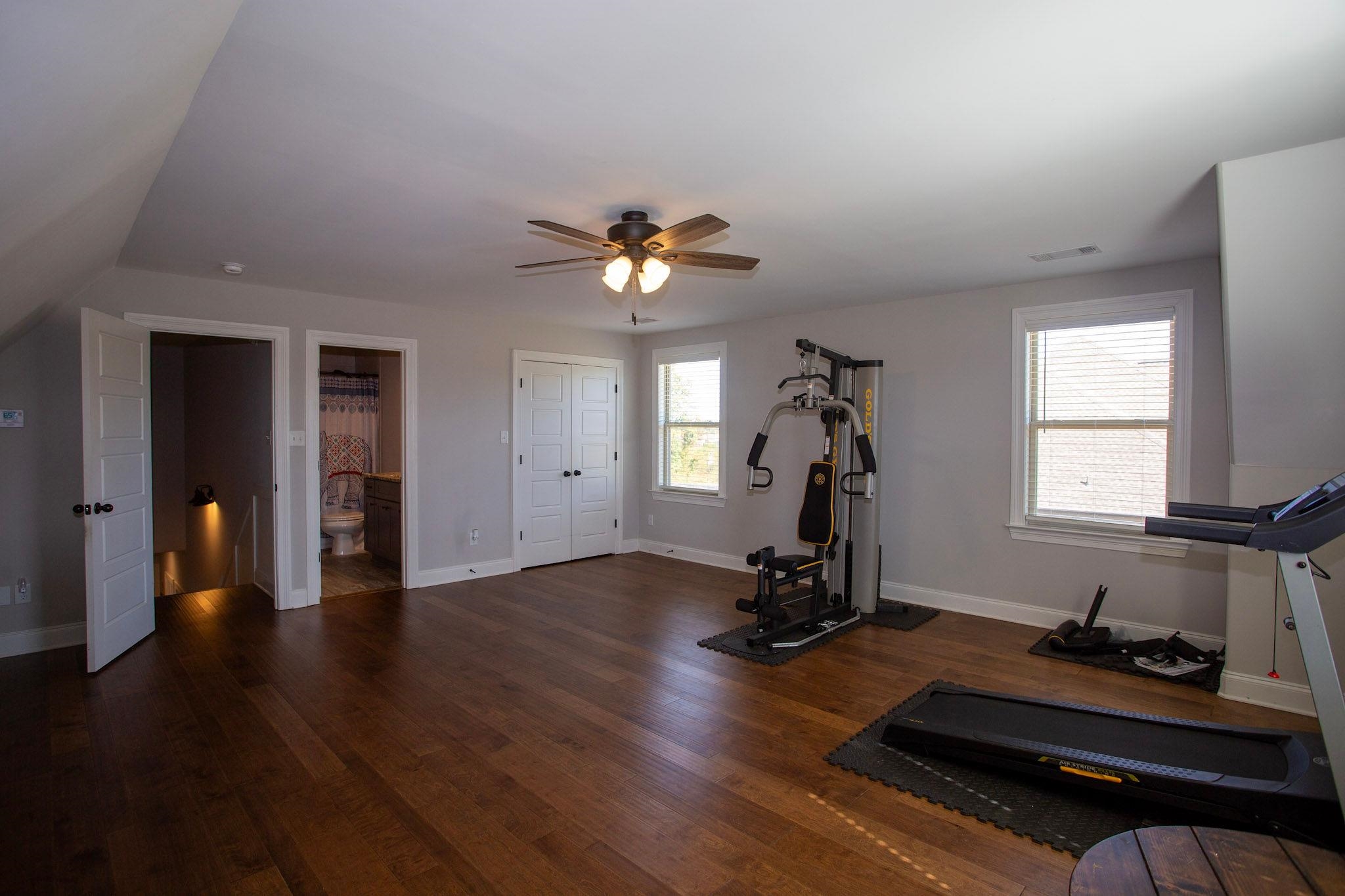 22 Cedar Ridge Cove Atoka, TN 38004 - Photo 19 of 39 Workout room featuring dark wood-type flooring, ceiling fan, and lofted ceiling