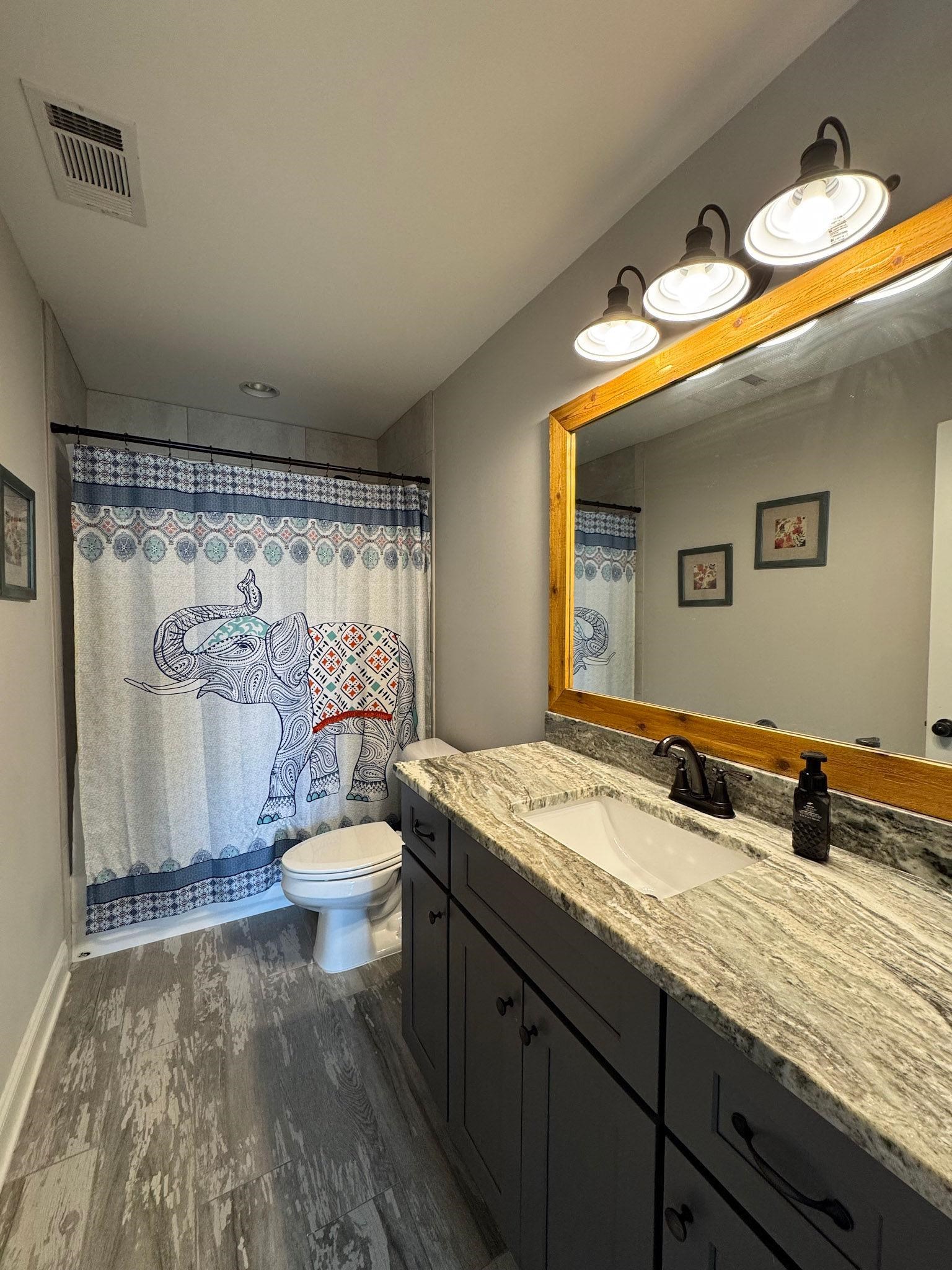 22 Cedar Ridge Cove Atoka, TN 38004 - Photo 20 of 39 Bathroom with toilet, hardwood / wood-style floors, walk in shower, and vanity