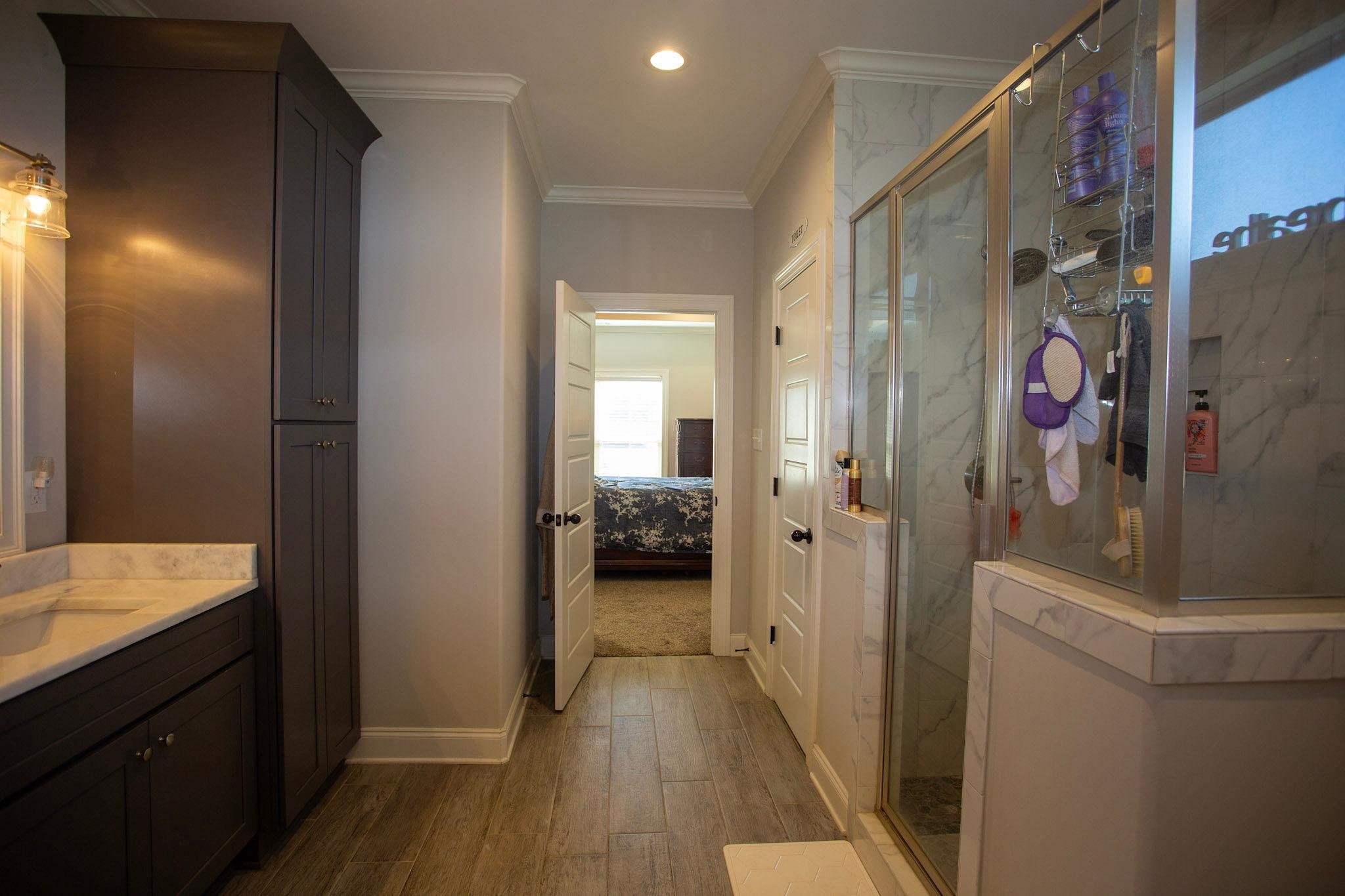 22 Cedar Ridge Cove Atoka, TN 38004 - Photo 23 of 39 Bathroom with vanity, crown molding, an enclosed shower, and hardwood / wood-style floors