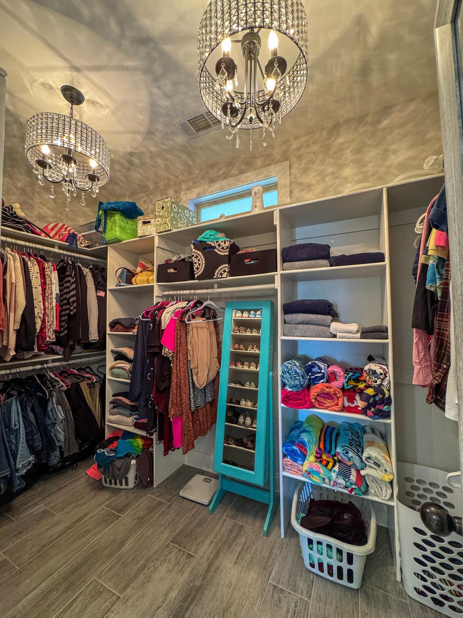 22 Cedar Ridge Cove Atoka, TN 38004 - Photo 25 of 39 Walk in closet featuring a chandelier and hardwood / wood-style flooring